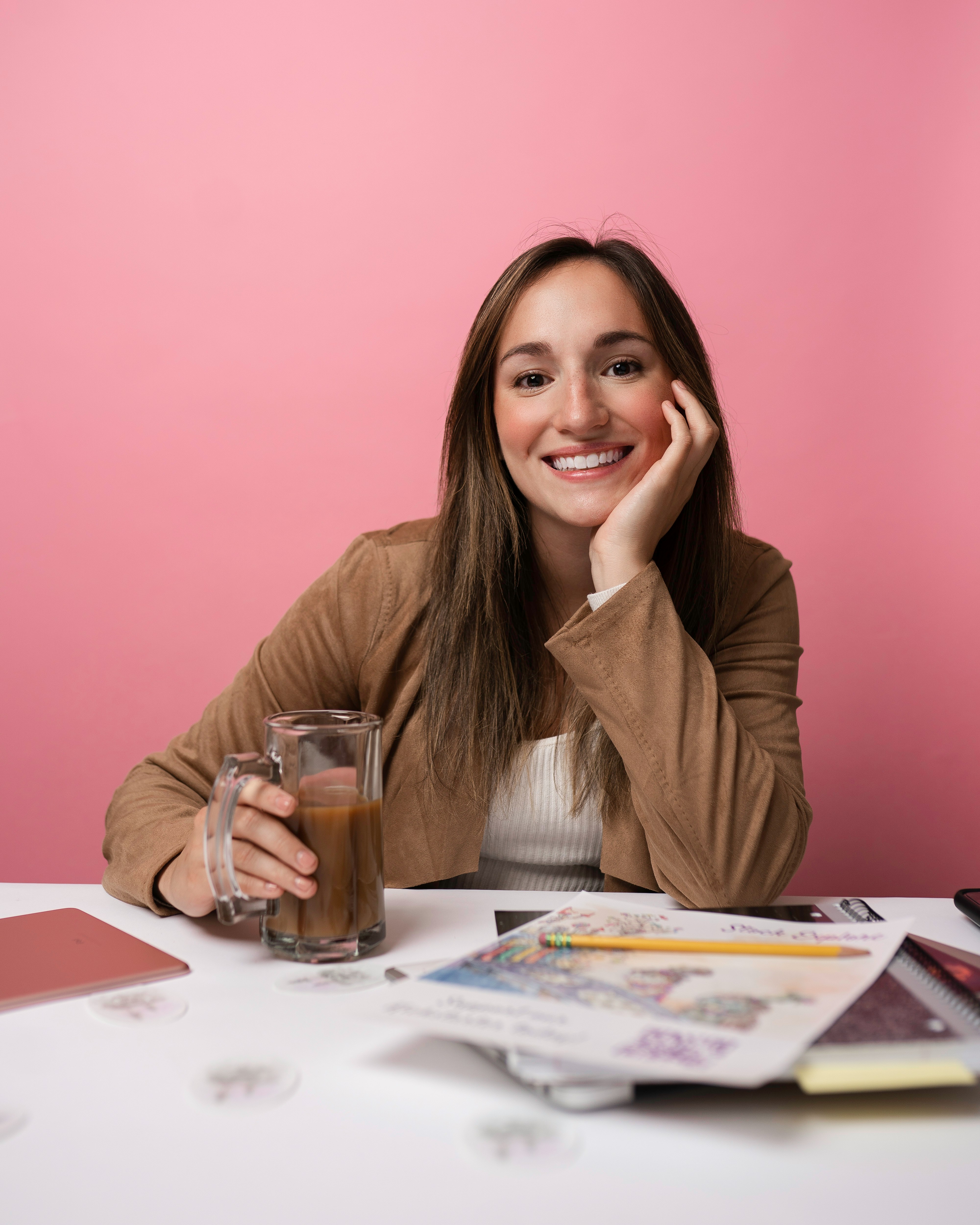Smiling woman with planner and coffee, calm and confident